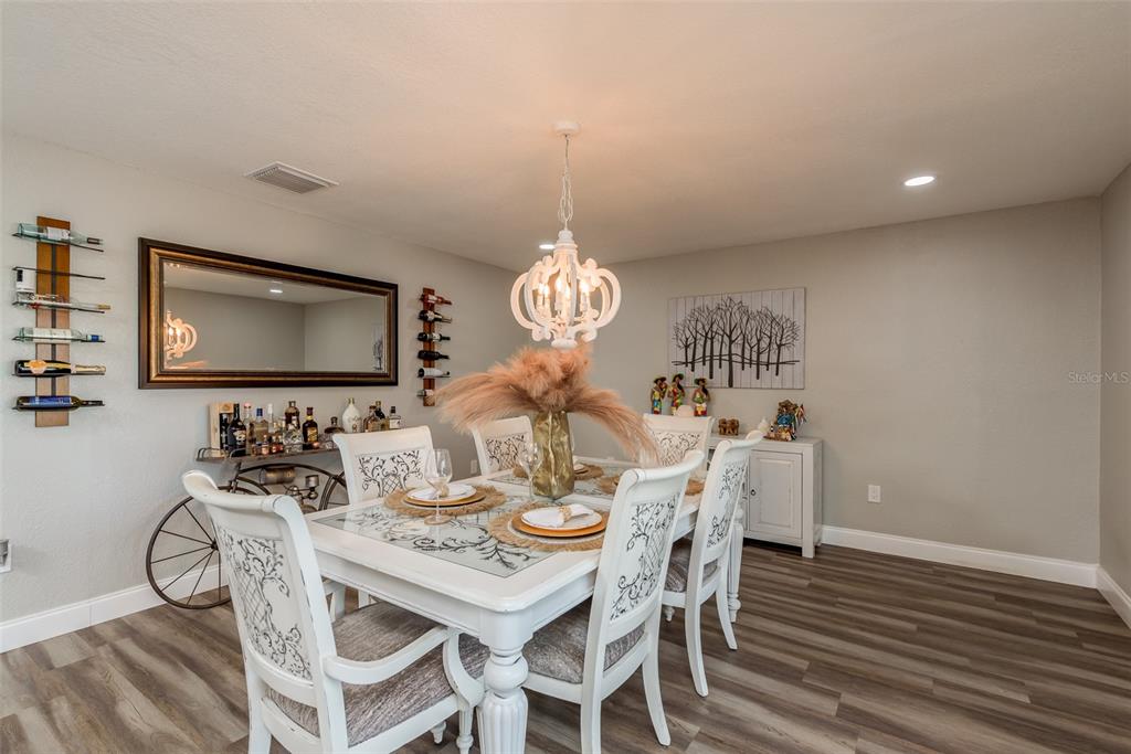 5534 Tropic Drive New Port Richey, FL 34653 - Photo 13 of 32 a view of a dining room with furniture and wooden floor