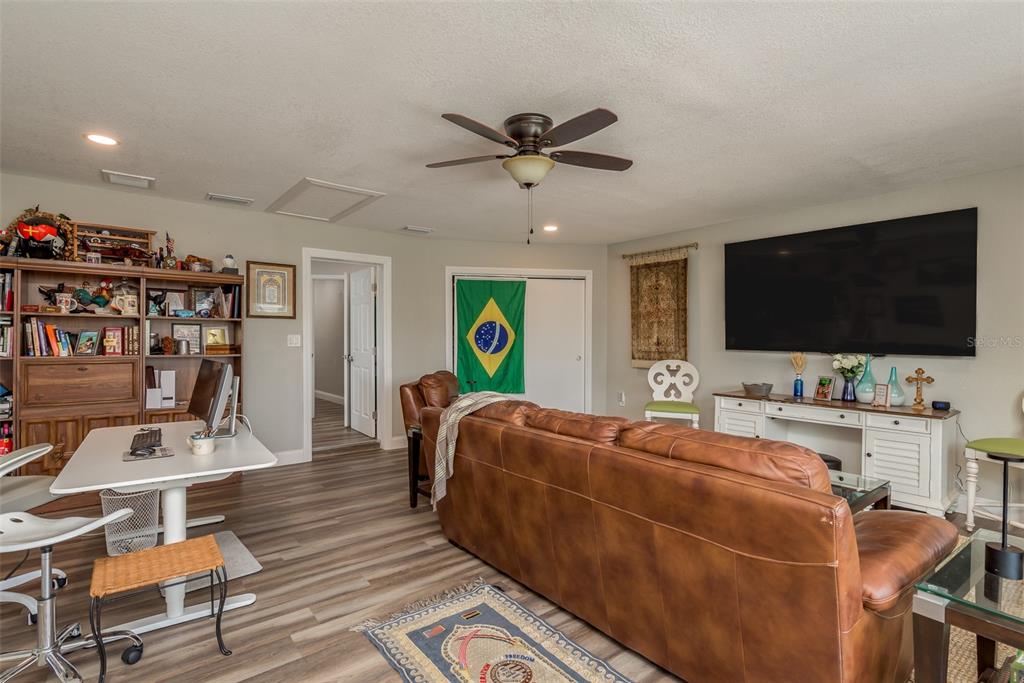5534 Tropic Drive New Port Richey, FL 34653 - Photo 16 of 32 a living room with furniture and a flat screen tv