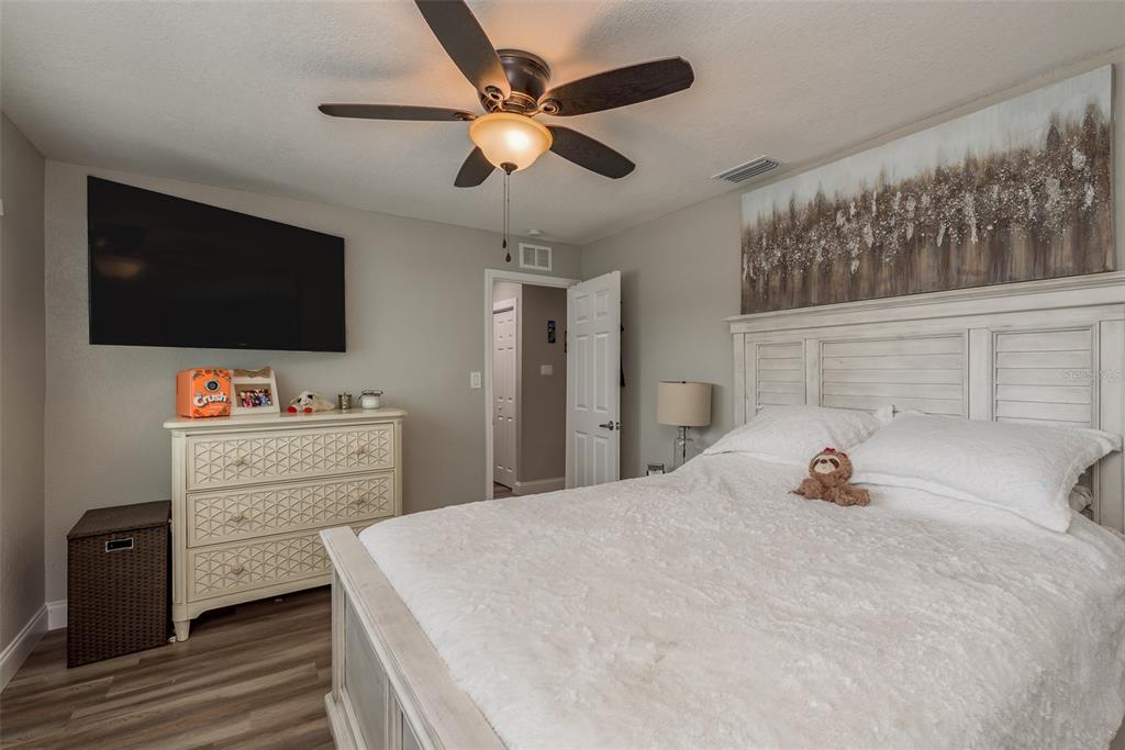 5534 Tropic Drive New Port Richey, FL 34653 - Photo 20 of 32 a bedroom with a bed and a flat screen tv