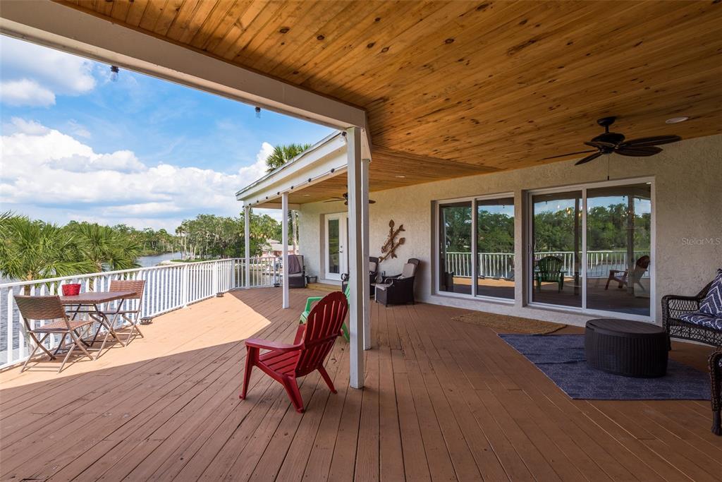 5534 Tropic Drive New Port Richey, FL 34653 - Photo 22 of 32 a view of a patio with a dining table and chairs with wooden floor