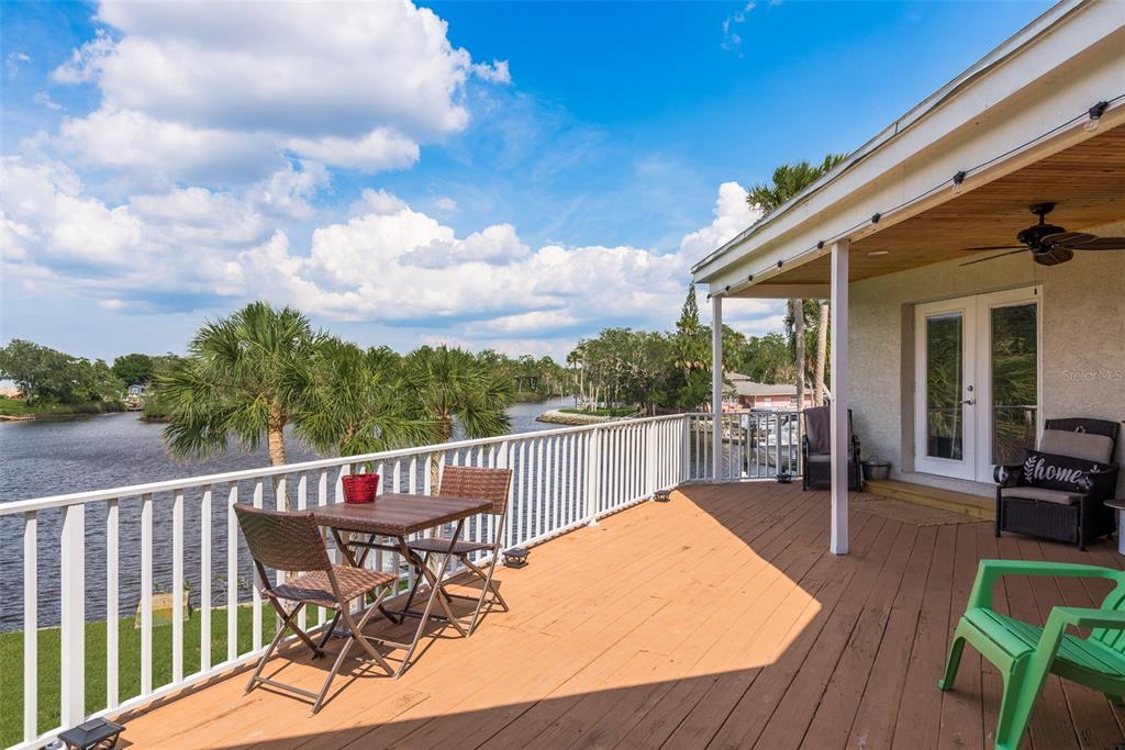 5534 Tropic Drive New Port Richey, FL 34653 - Photo 23 of 32 a view of a chair and tables on the roof deck