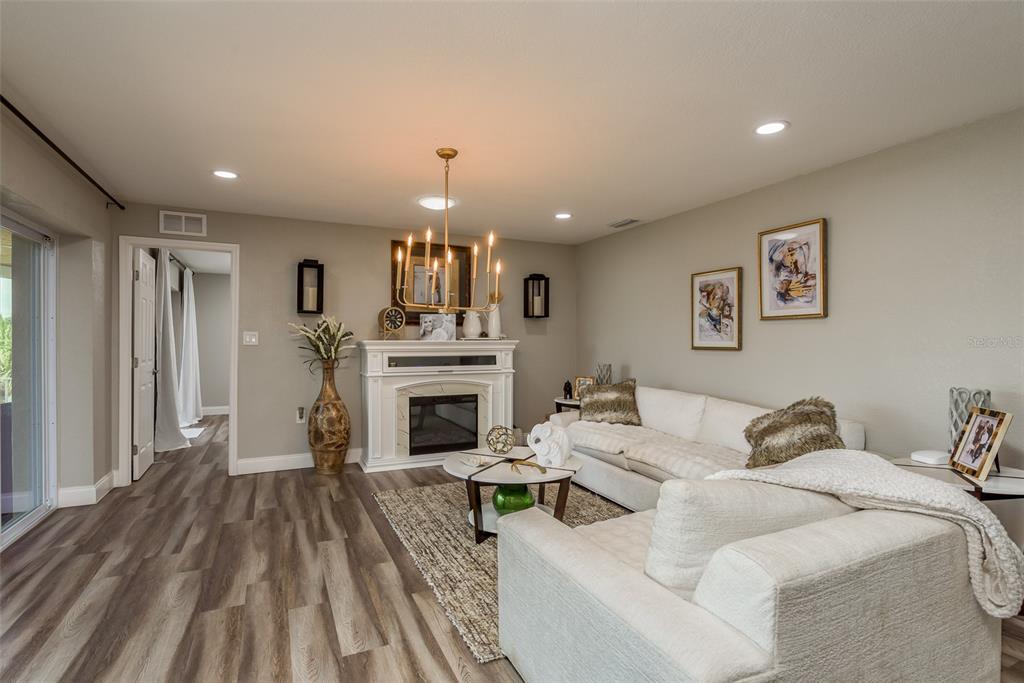 5534 Tropic Drive New Port Richey, FL 34653 - Photo 8 of 32 a living room with furniture and a fireplace