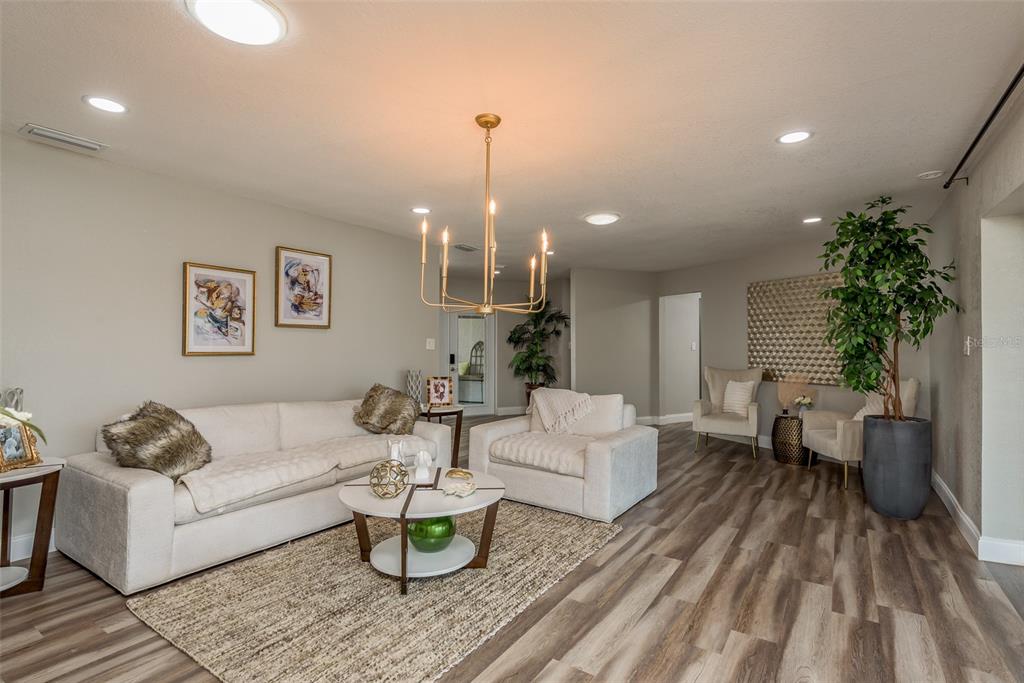 5534 Tropic Drive New Port Richey, FL 34653 - Photo 9 of 32 a living room with furniture and a chandelier