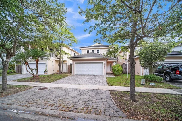 a view of a house with a yard and garage