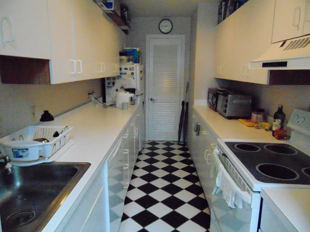 10 Weston Avenue, Unit 430 Quincy, MA 02170 - Photo 3 of 9 a kitchen with a sink a stove and cabinets