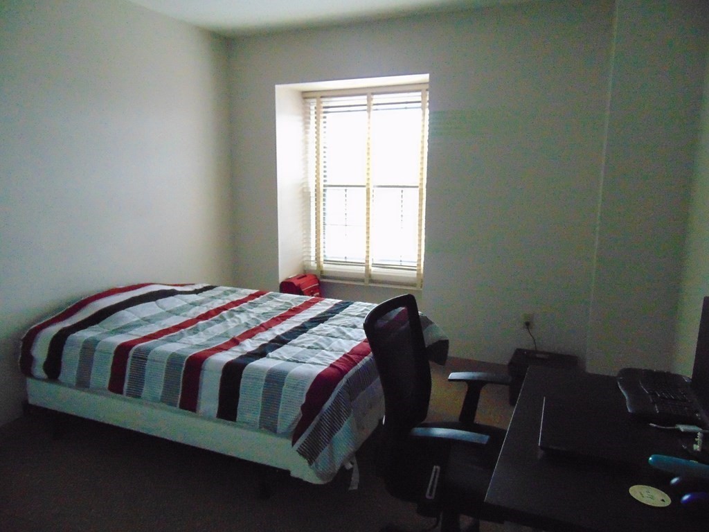 10 Weston Avenue, Unit 430 Quincy, MA 02170 - Photo 6 of 9 a bedroom with a bed chair and a window