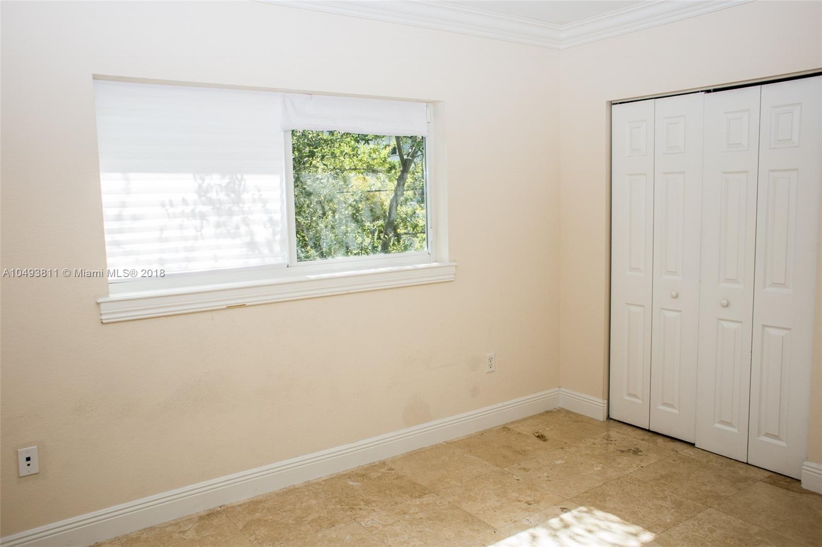 2980 Virginia Street, Unit 2980 Miami, FL 33133 - Photo 13 of 17 an empty room with a window