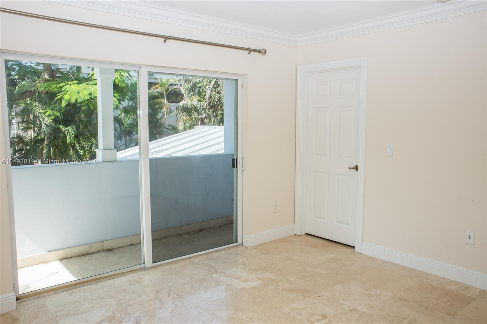 2980 Virginia Street, Unit 2980 Miami, FL 33133 - Photo 15 of 17 an empty room with large windows