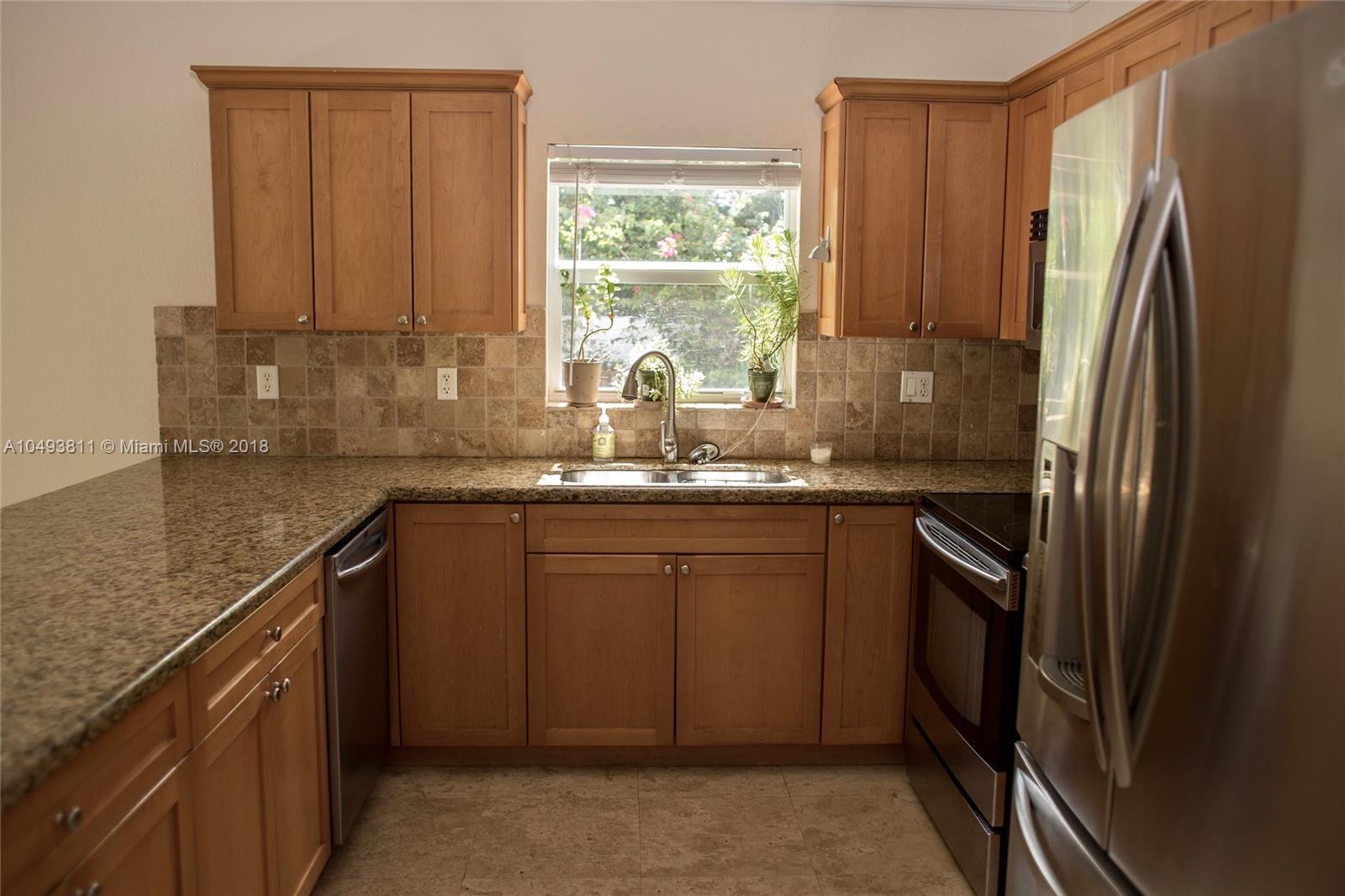 2980 Virginia Street, Unit 2980 Miami, FL 33133 - Photo 5 of 17 a kitchen with stainless steel appliances granite countertop a refrigerator sink and cabinets
