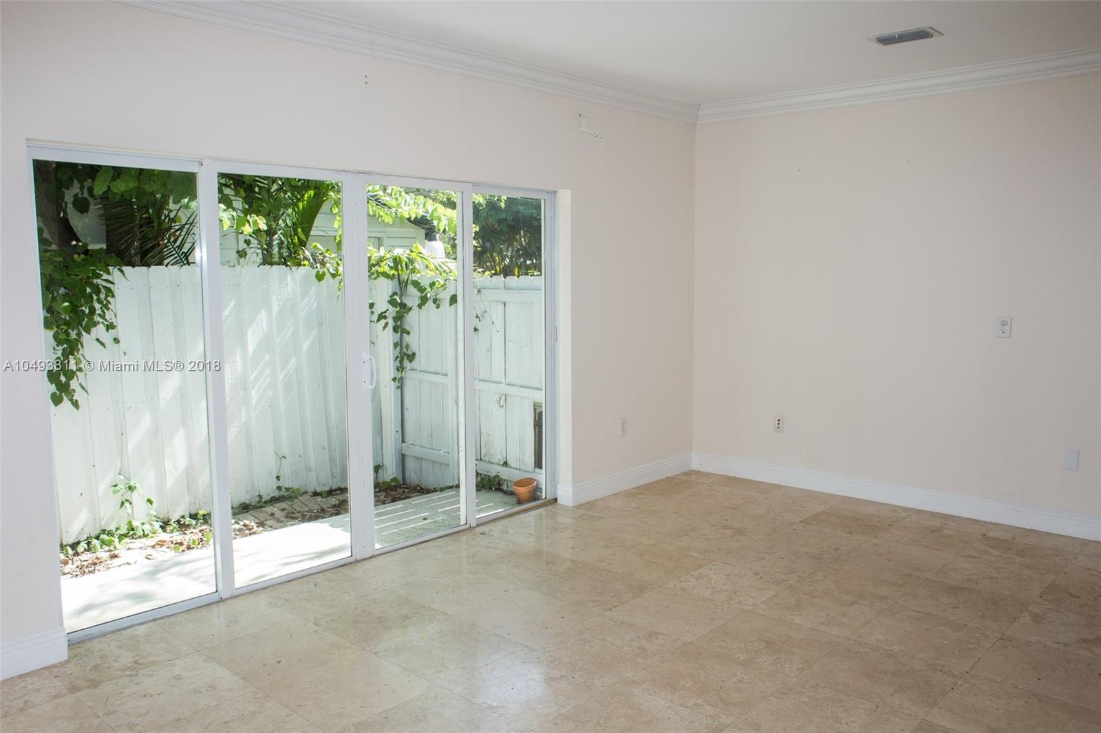 2980 Virginia Street, Unit 2980 Miami, FL 33133 - Photo 8 of 17 an empty room with a window