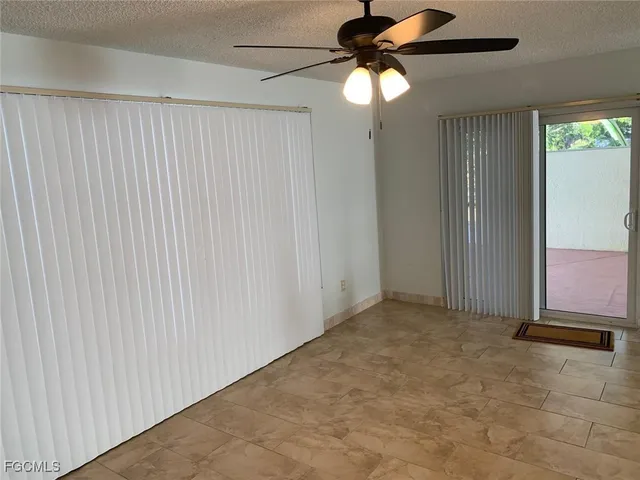 an empty room with a chandelier fan