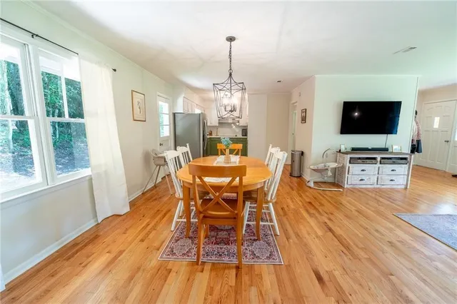 a view of a kitchen with cabinets and wooden floor
