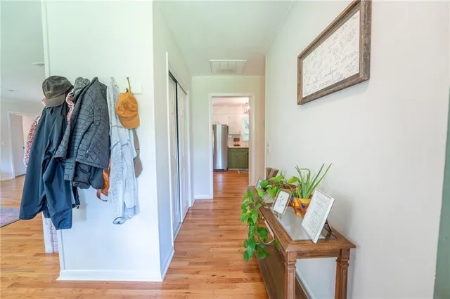 a kitchen with stainless steel appliances a refrigerator and wooden floor