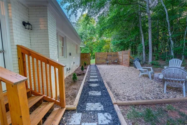 a view of a backyard with plants and a backyard