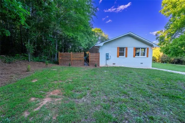 a view of a backyard with barn and large trees