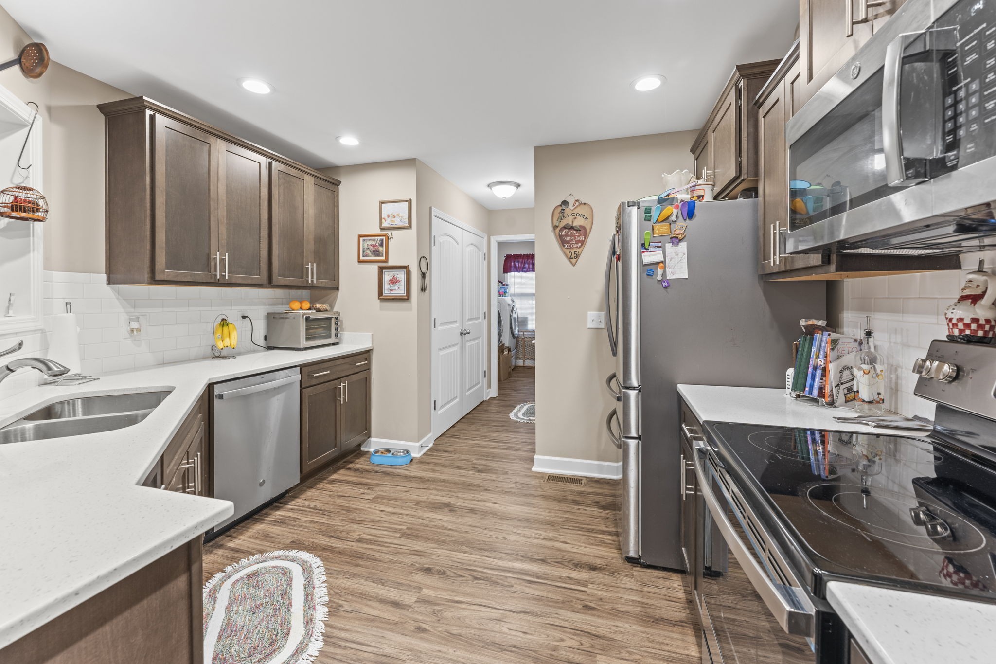 110 Saddle Street Manchester, TN 37355 - Photo 13 of 35 a kitchen with a refrigerator a sink and wooden cabinets