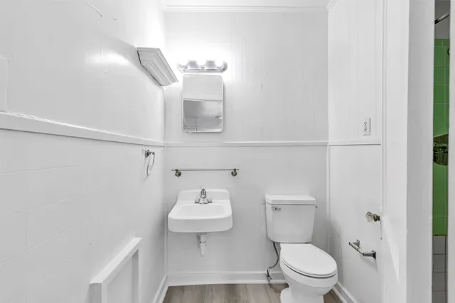 a bathroom with a sink toilet and mirror