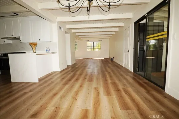 a view of a room with wooden floor and cabinet
