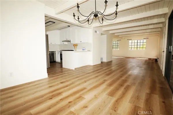 a view of a room with wooden floor and cabinet