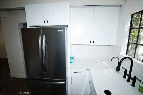 a close view of a sink and cabinets in a kitchen
