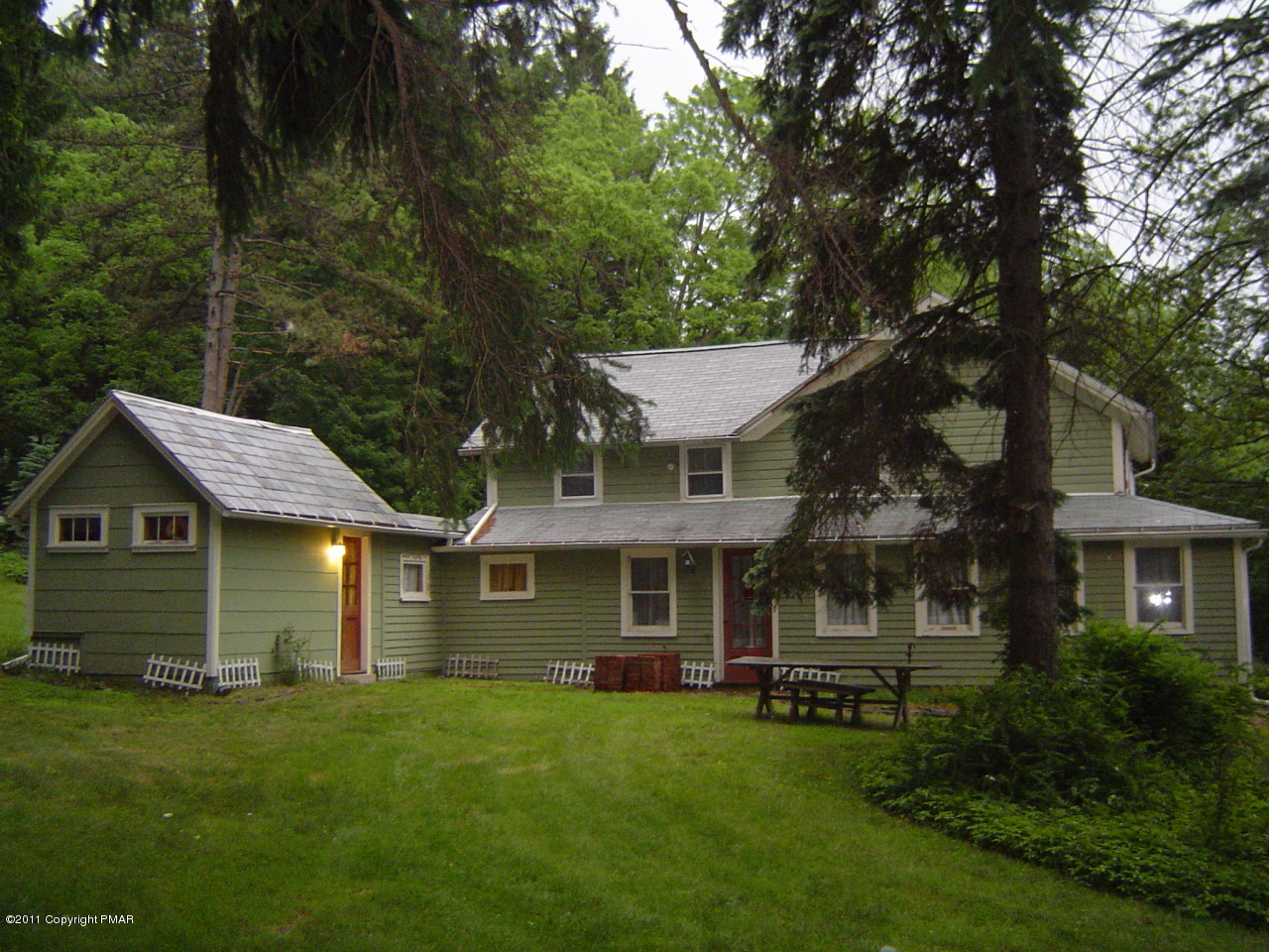 8164 West Rinker Road Stroudsburg, PA 18360 - Photo 11 of 14 a front view of a house with a garden