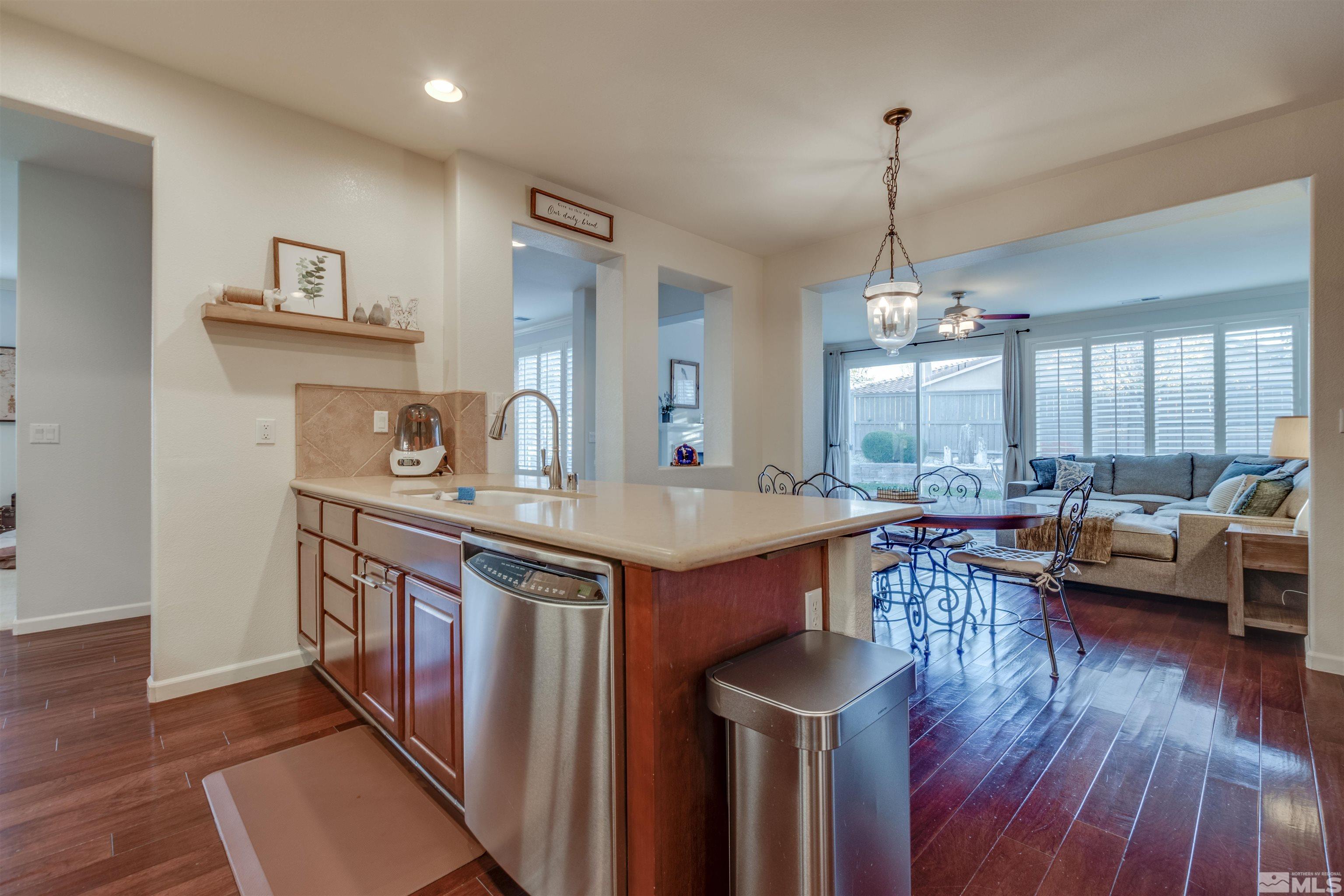 450 Haleb Court Reno, NV 89521 - Photo 11 of 31 a kitchen with stainless steel appliances granite countertop a stove and a wooden floors