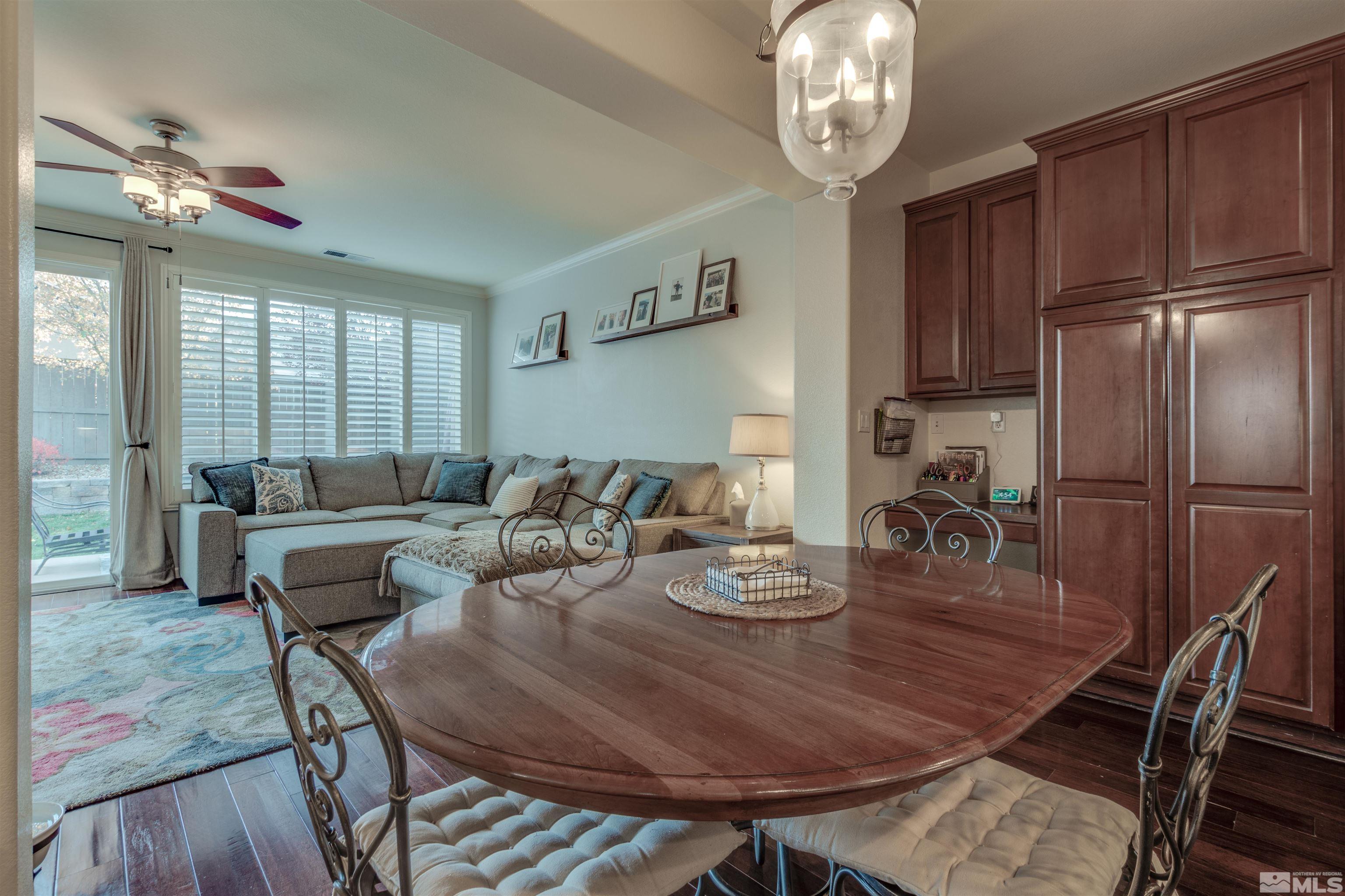 450 Haleb Court Reno, NV 89521 - Photo 12 of 31 a view of a dining room with furniture a chandelier and wooden floor