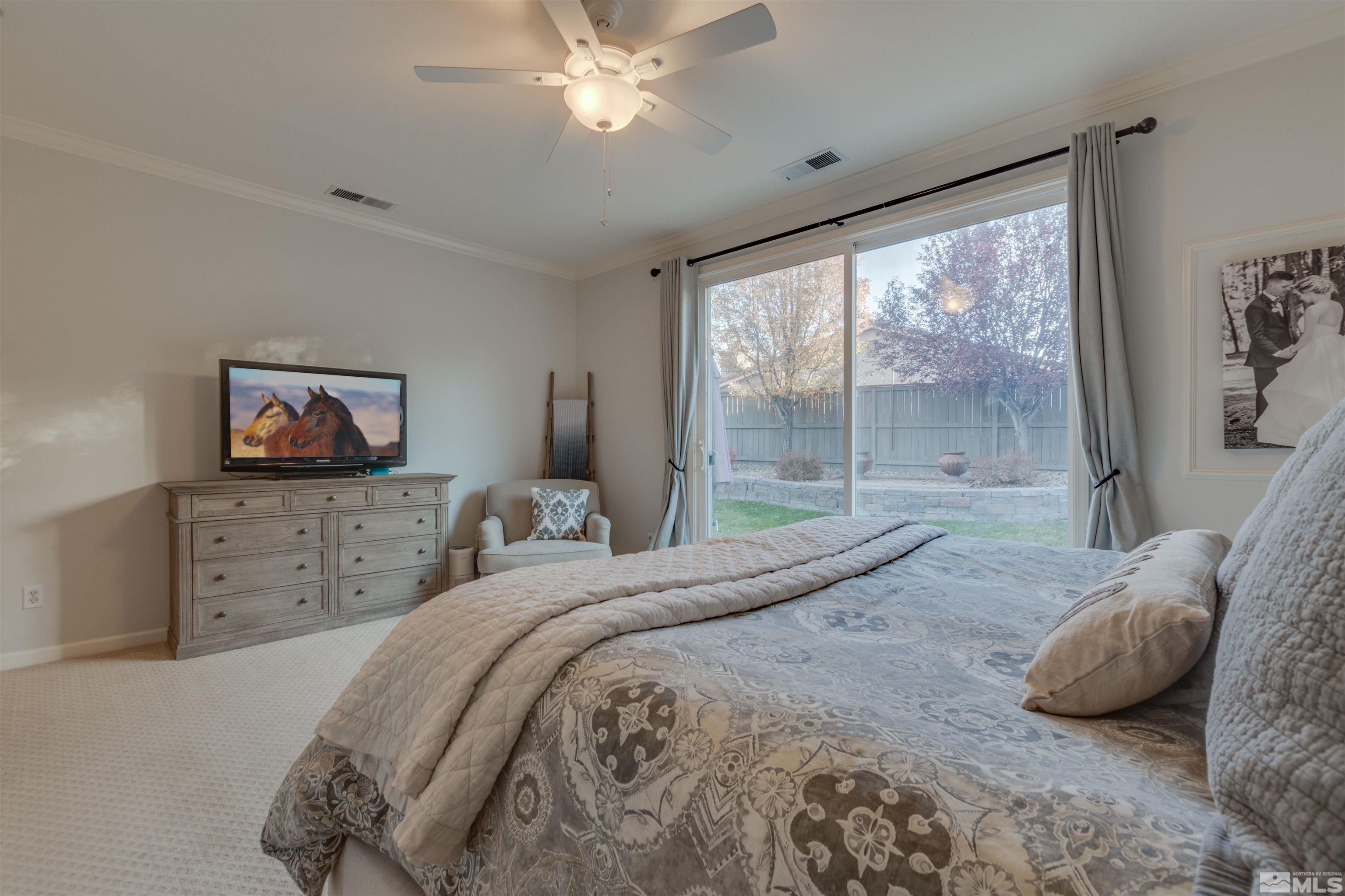 450 Haleb Court Reno, NV 89521 - Photo 23 of 31 a bedroom with a large bed and a flat screen tv