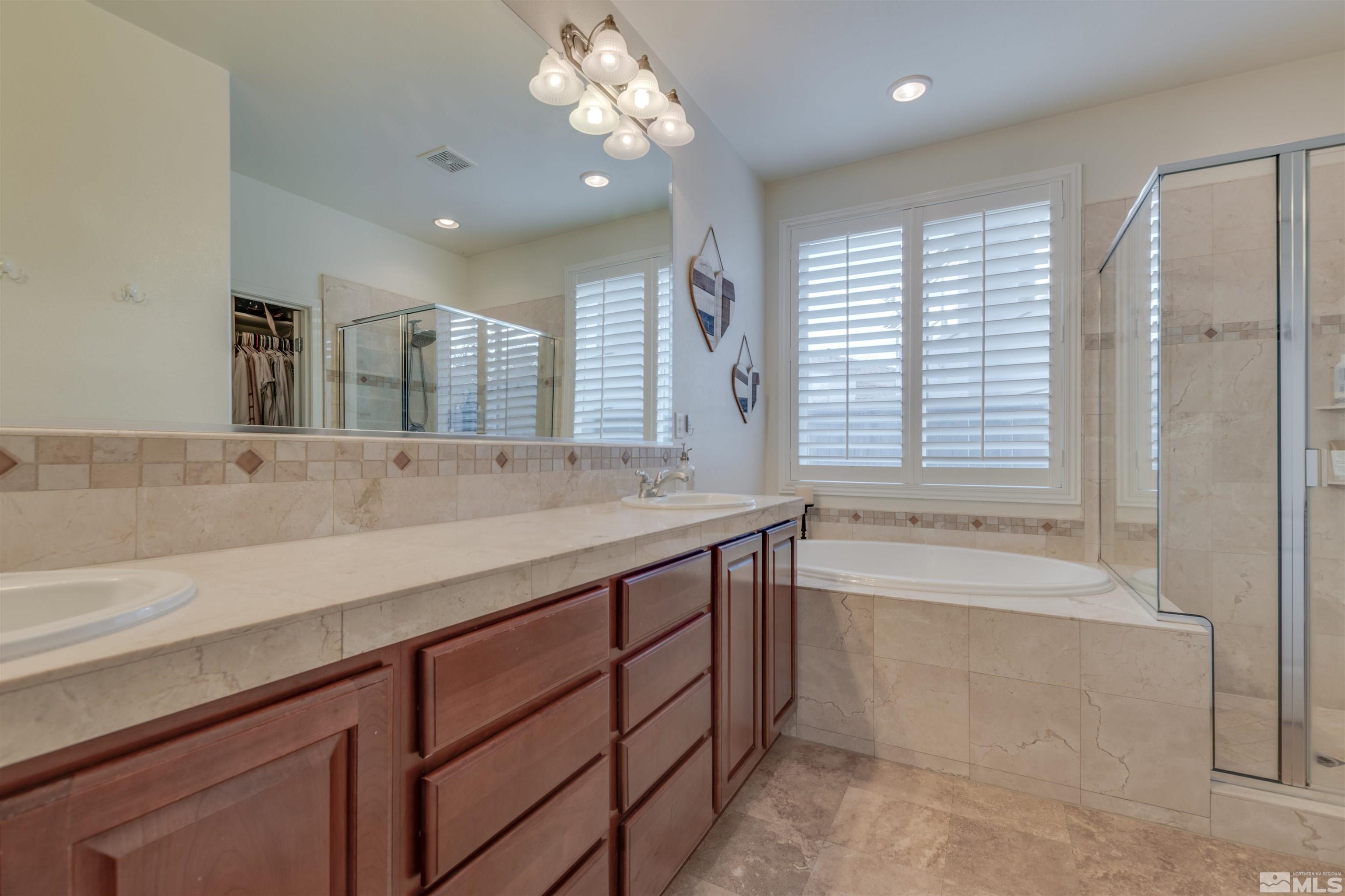 450 Haleb Court Reno, NV 89521 - Photo 24 of 31 a spacious bathroom with a large tub sink and mirror