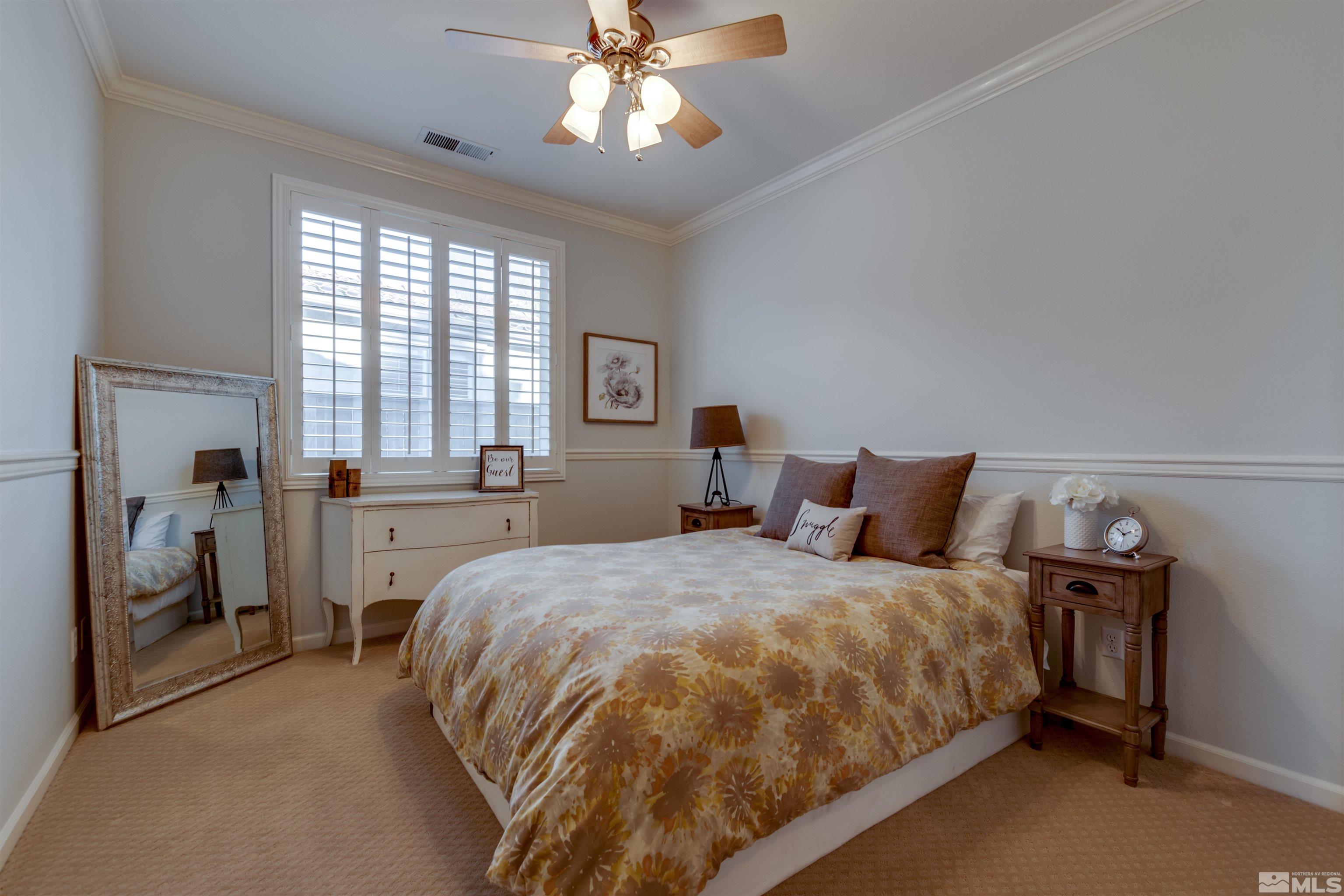 450 Haleb Court Reno, NV 89521 - Photo 30 of 31 a bedroom with a bed and a chandelier