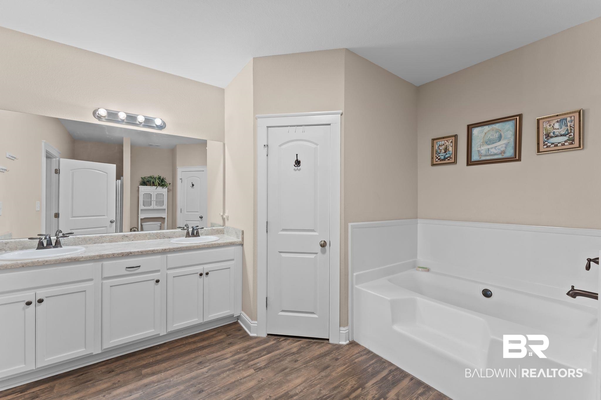 28980 Comstock Road Elberta, AL 36530 - Photo 18 of 38 Full bathroom with double vanity, a bath, and dark wood-style floors