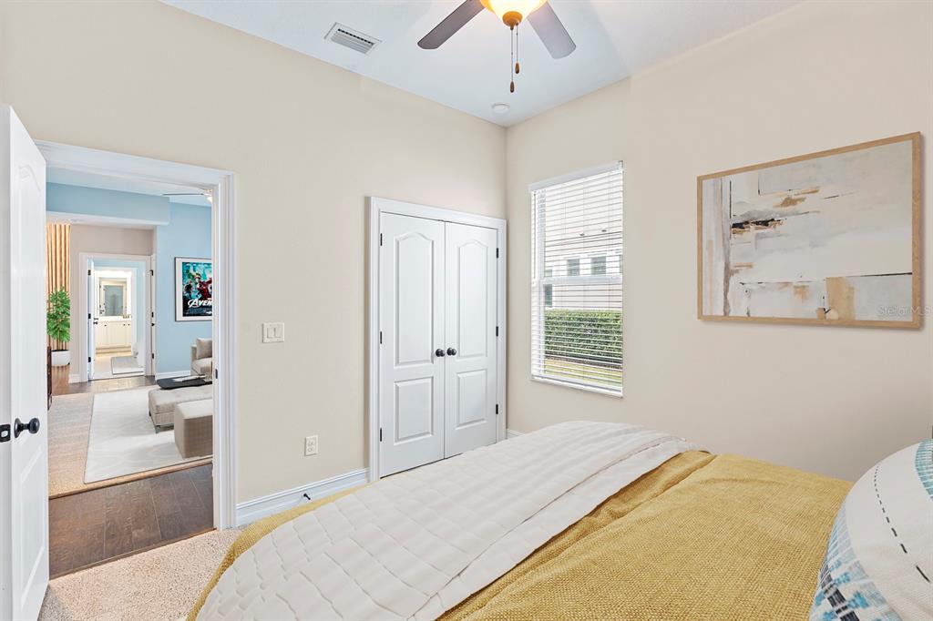6809 Scenic Drive Apollo Beach, FL 33572 - Photo 14 of 94 a bedroom with a bed and a chandelier