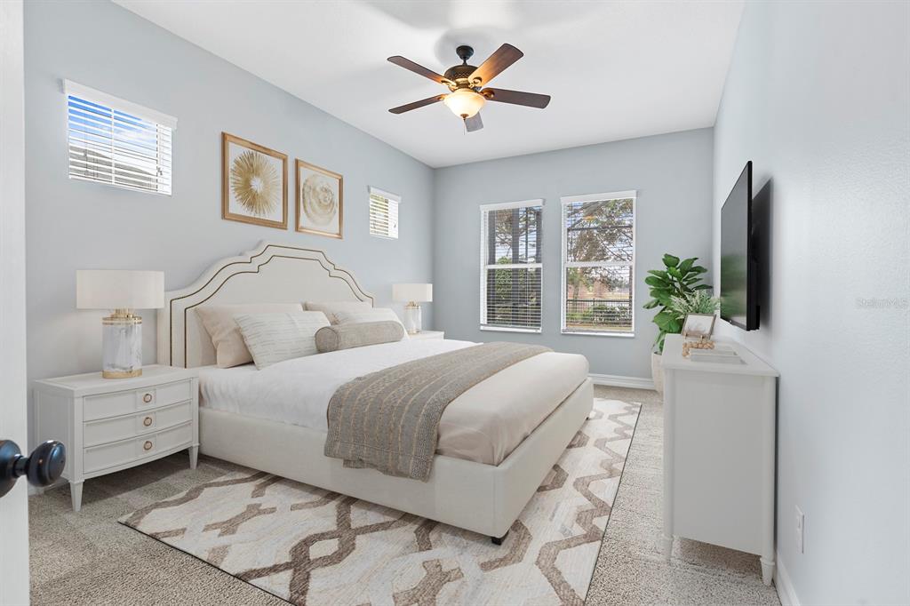 6809 Scenic Drive Apollo Beach, FL 33572 - Photo 5 of 94 a bedroom with a bed and a flat screen tv