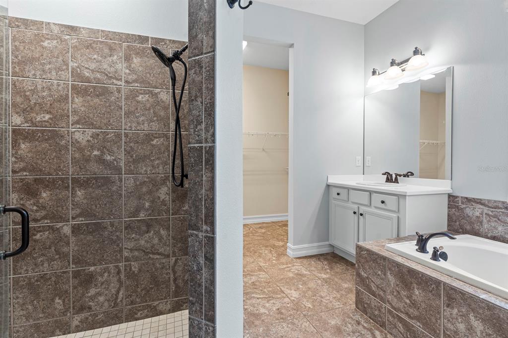 6809 Scenic Drive Apollo Beach, FL 33572 - Photo 58 of 94 a bathroom with a double vanity sink a toilet a mirror and shower