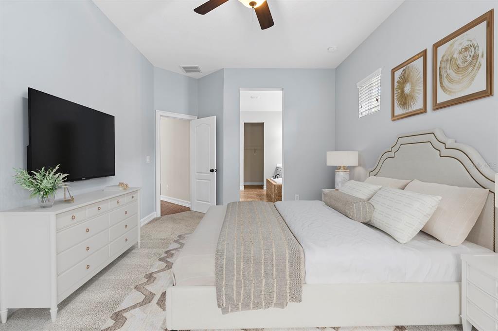 6809 Scenic Drive Apollo Beach, FL 33572 - Photo 6 of 94 a bedroom with a bed a flat screen tv and a potted plant