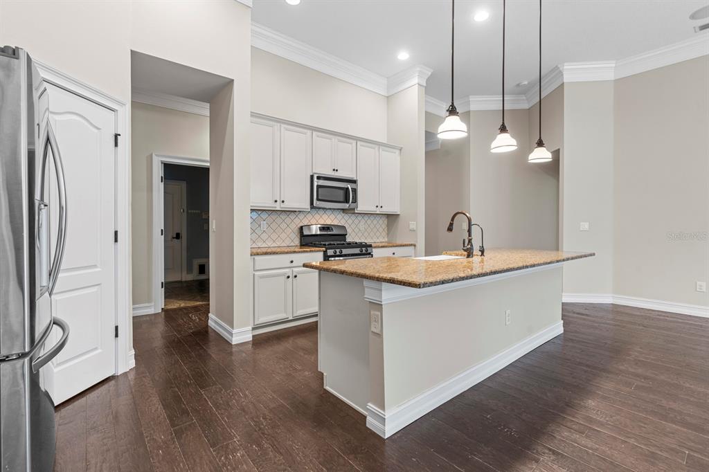 6809 Scenic Drive Apollo Beach, FL 33572 - Photo 65 of 94 a large kitchen with a large counter top space a sink stainless steel appliances and cabinets