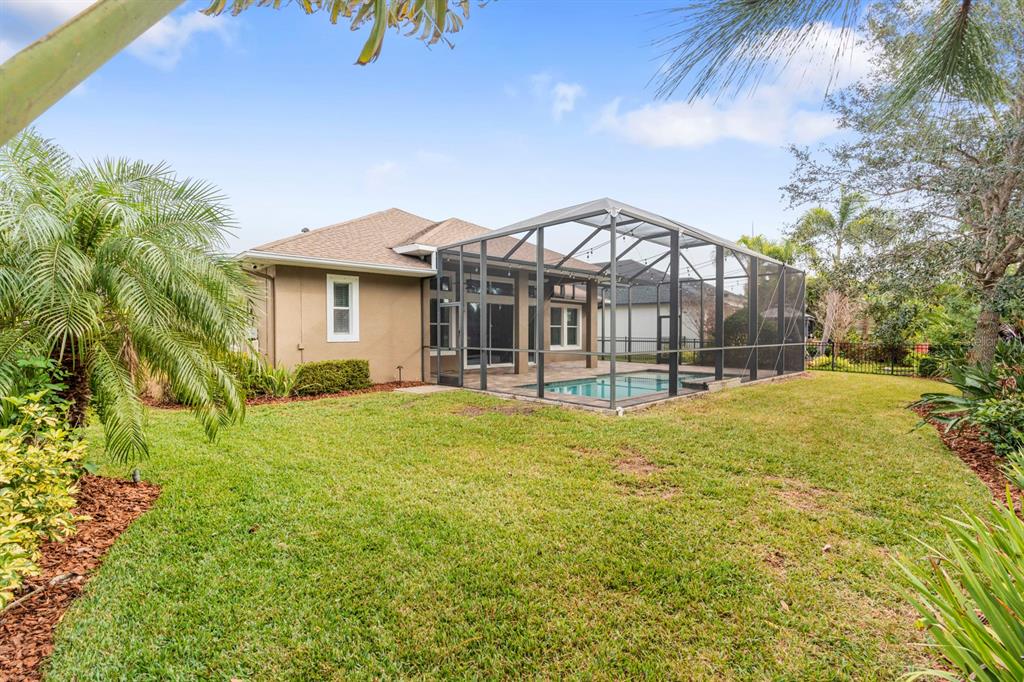 6809 Scenic Drive Apollo Beach, FL 33572 - Photo 80 of 94 a view of a house with a backyard and a garden