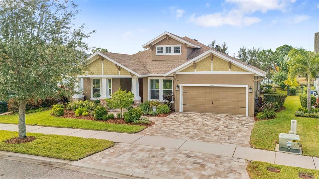 6809 Scenic Drive Apollo Beach, FL 33572 - Photo 85 of 94 a front view of a house with a yard and potted plants