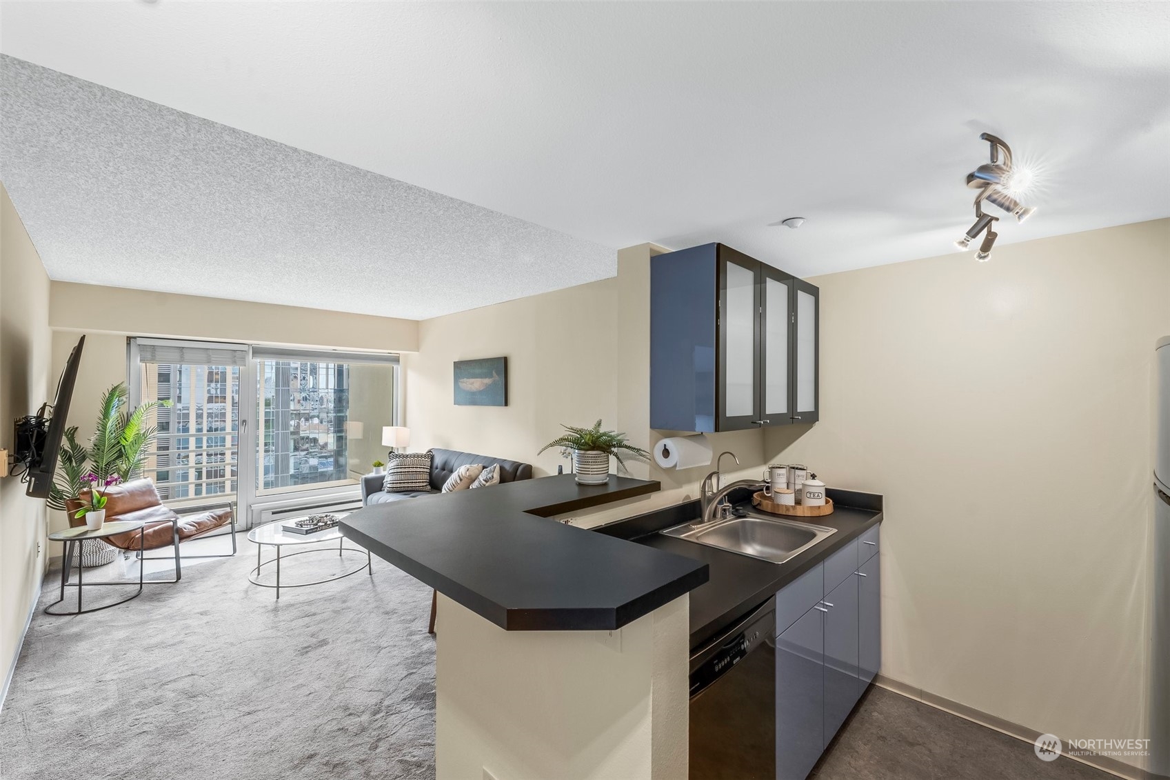 1415 2nd Avenue, Unit 1408 Seattle, WA 98101 - Photo 11 of 32 a kitchen with a stove a sink and a refrigerator