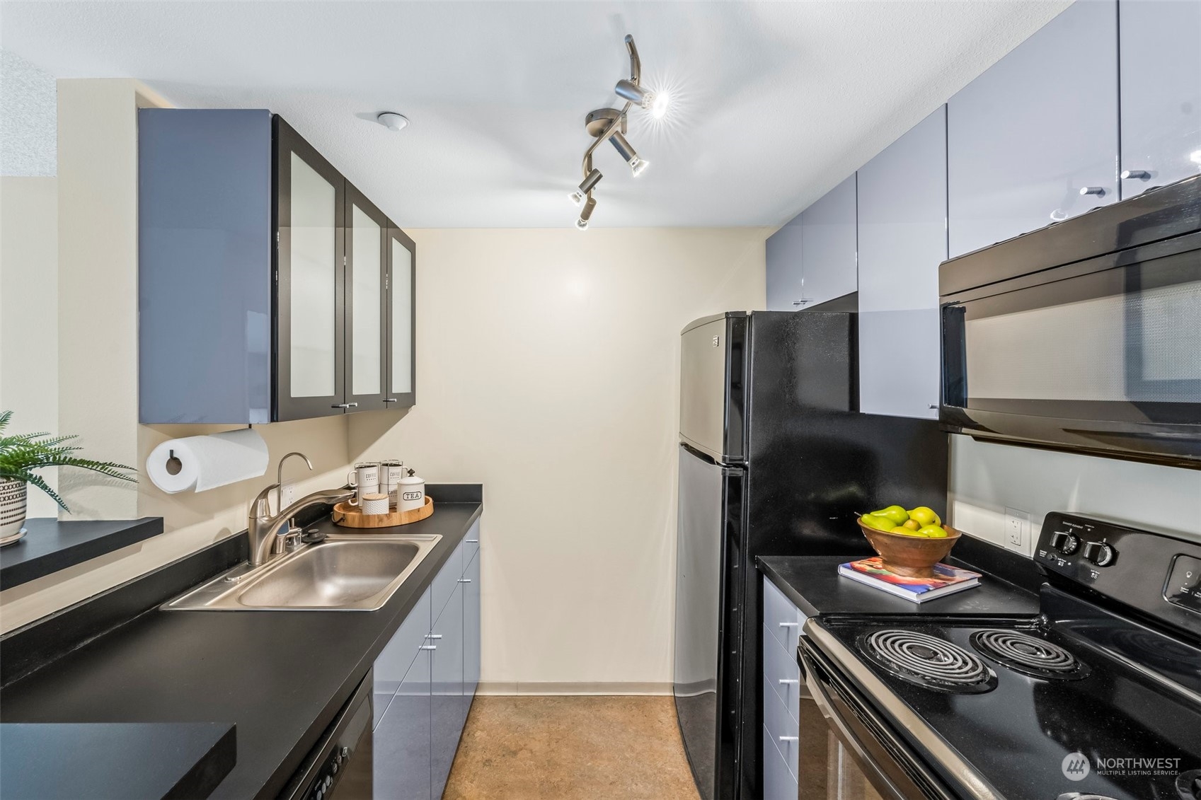 1415 2nd Avenue, Unit 1408 Seattle, WA 98101 - Photo 12 of 32 a kitchen with stainless steel appliances granite countertop a sink and a stove