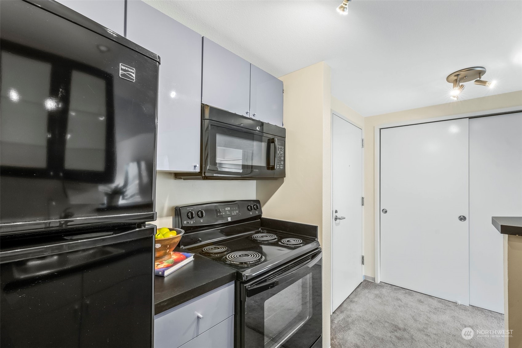 1415 2nd Avenue, Unit 1408 Seattle, WA 98101 - Photo 13 of 32 a kitchen with a stove and a microwave