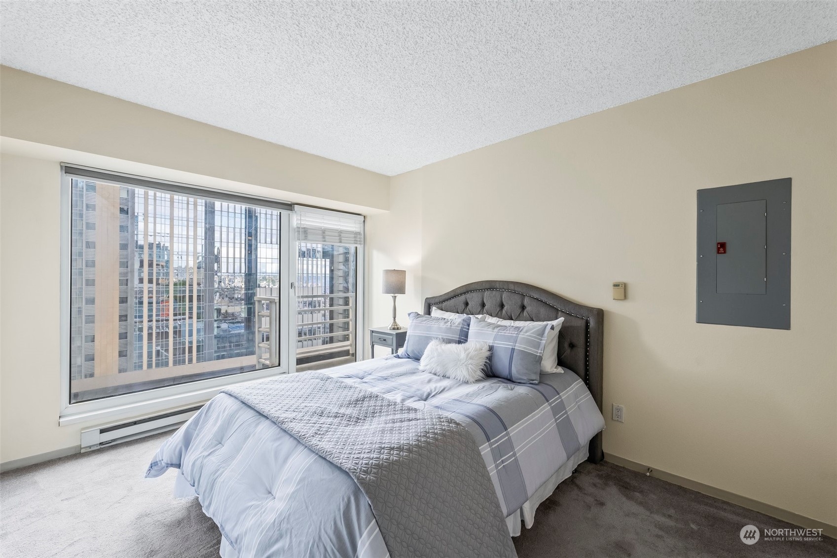 1415 2nd Avenue, Unit 1408 Seattle, WA 98101 - Photo 16 of 32 a bedroom with a large bed and a large window