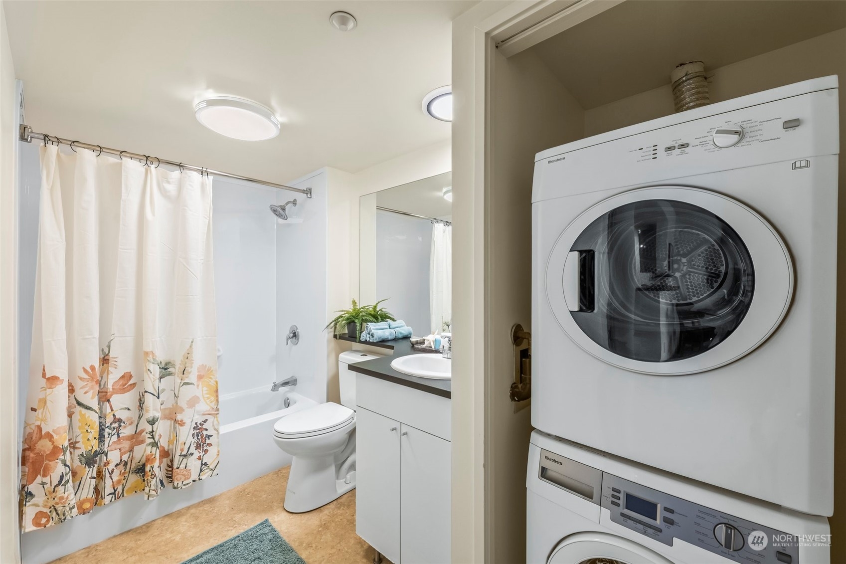 1415 2nd Avenue, Unit 1408 Seattle, WA 98101 - Photo 17 of 32 a view of a hallway with washer and dryer
