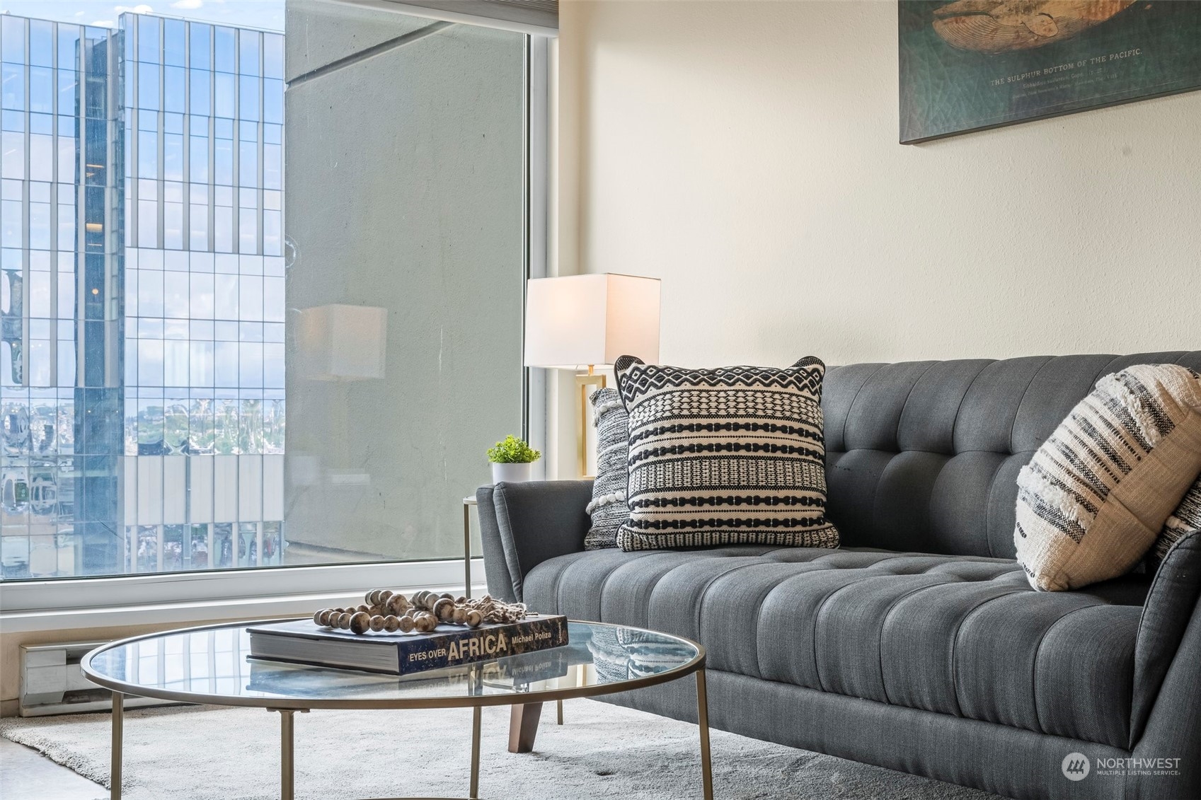 1415 2nd Avenue, Unit 1408 Seattle, WA 98101 - Photo 2 of 32 a living room with furniture and a potted plant