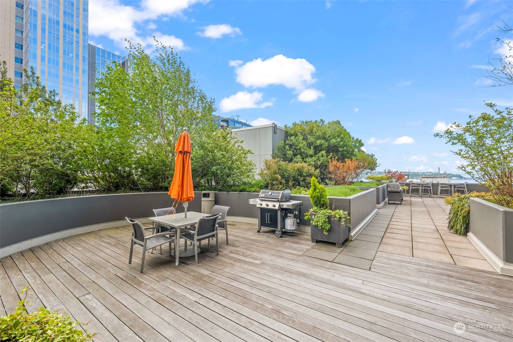 1415 2nd Avenue, Unit 1408 Seattle, WA 98101 - Photo 25 of 32 a view of a chairs and table on the wooden deck
