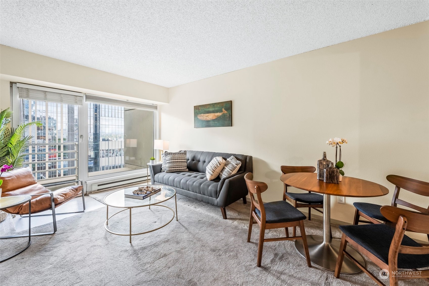 1415 2nd Avenue, Unit 1408 Seattle, WA 98101 - Photo 6 of 32 a living room with furniture and a floor to ceiling window