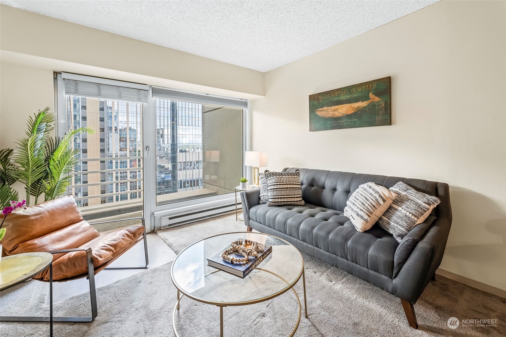 1415 2nd Avenue, Unit 1408 Seattle, WA 98101 - Photo 7 of 32 a living room with furniture and a large window
