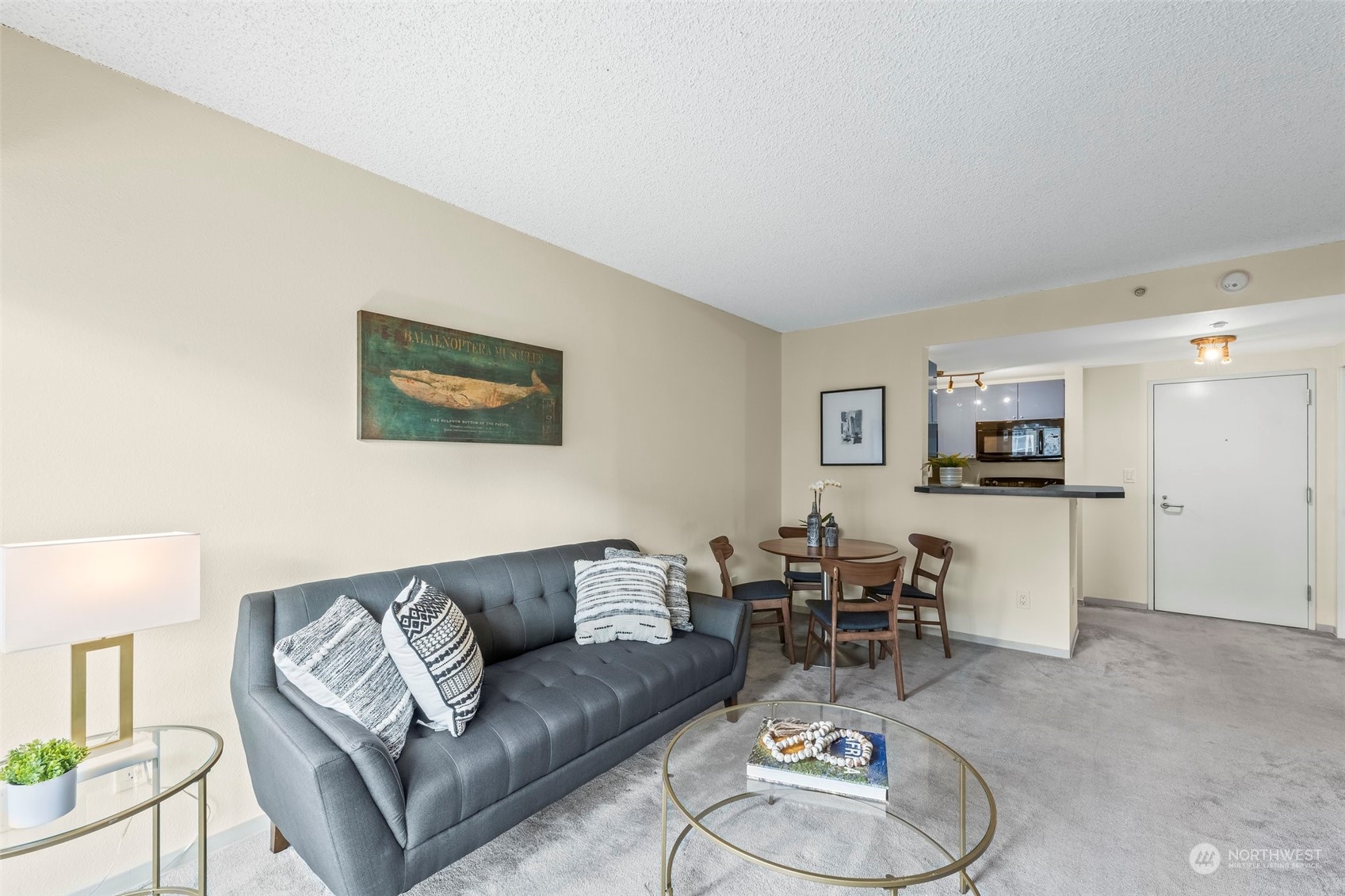 1415 2nd Avenue, Unit 1408 Seattle, WA 98101 - Photo 8 of 32 a living room with furniture and a wooden floor