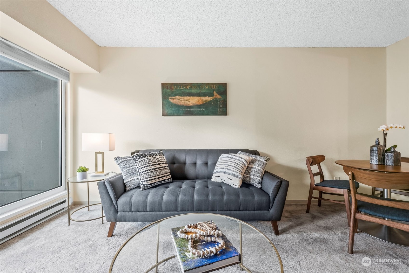 1415 2nd Avenue, Unit 1408 Seattle, WA 98101 - Photo 9 of 32 a living room with furniture and a window