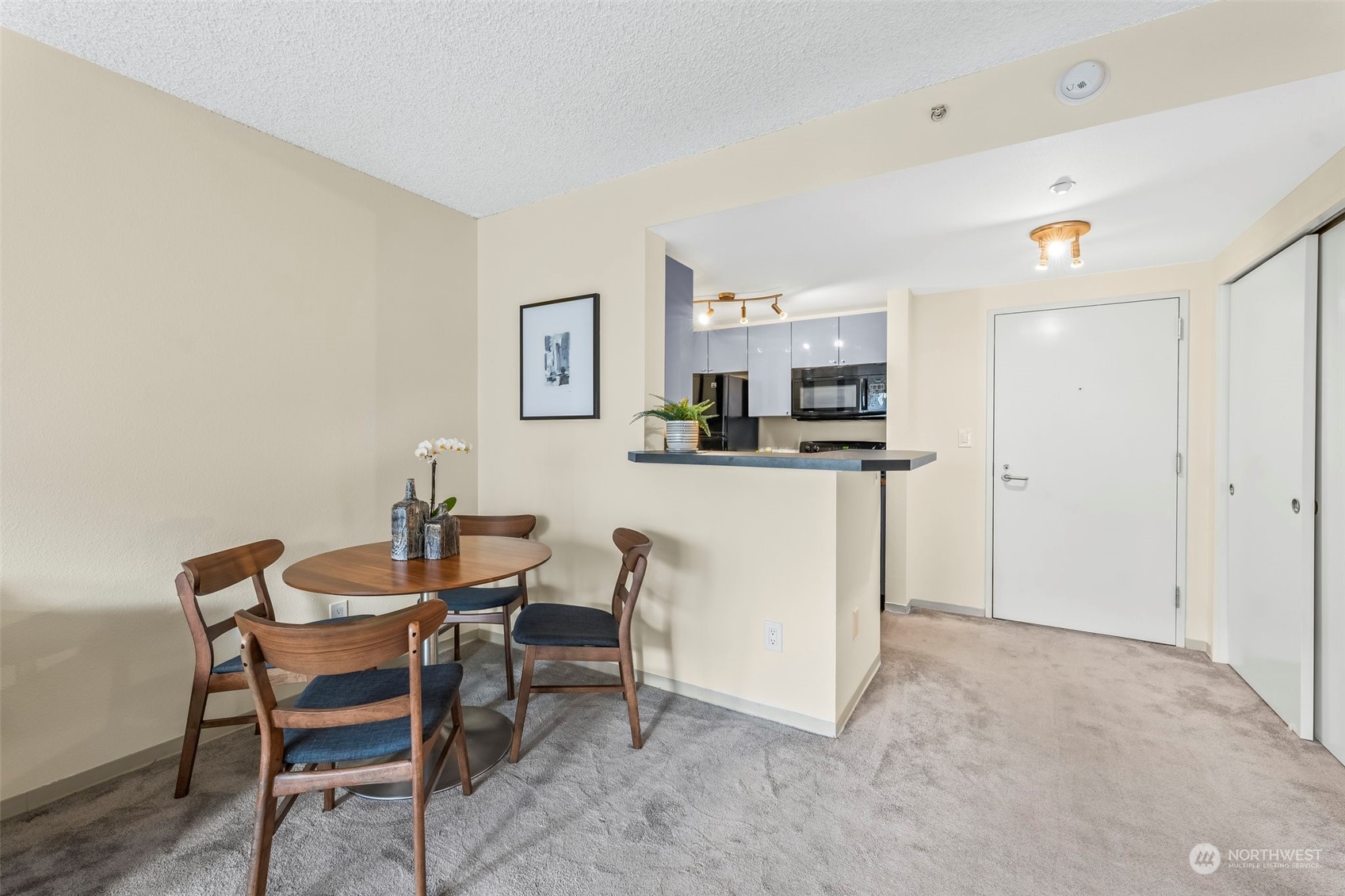 1415 2nd Avenue, Unit 1408 Seattle, WA 98101 - Photo 10 of 32 a view of a dining room with furniture and a kitchen